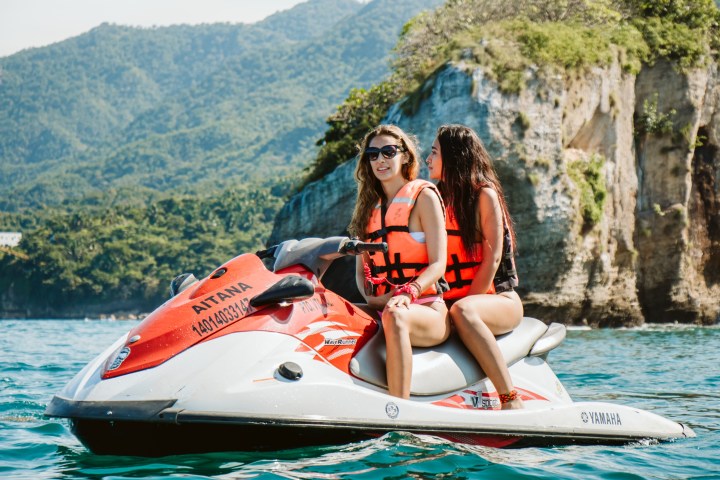 a person riding on the back of a boat in the water