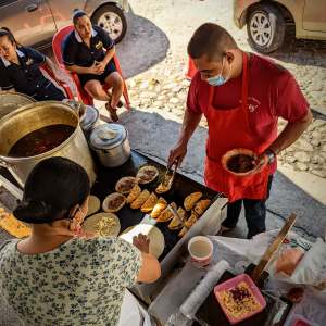 a group of people sitting at a table with food